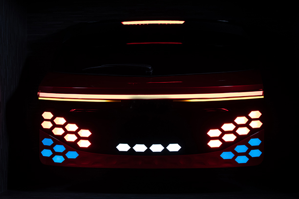 Back of a Ulcetech car with red, yellow and blue light and black background