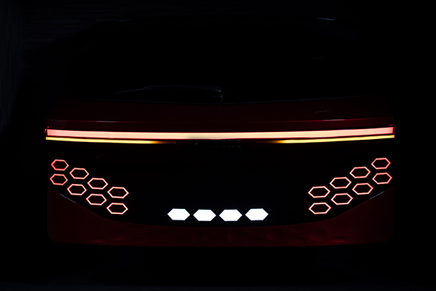 Back of a Ulcetech car with red and yellow light and black background