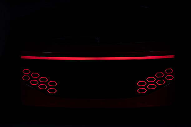 Back of a Ulcetech car with red light and black background