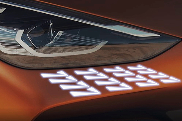 Head light of an orange Ulcetech car